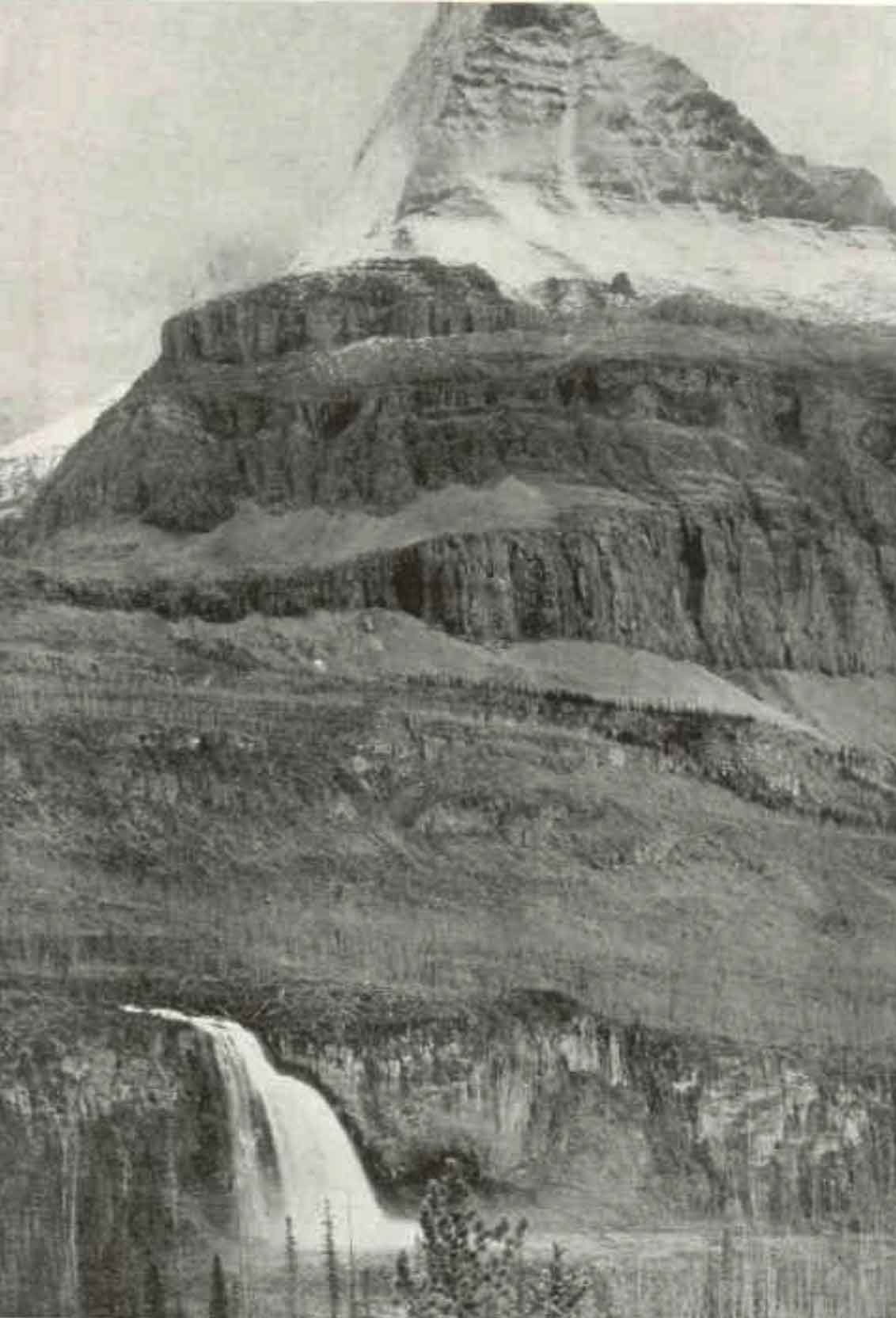 The north face of Mount Robson rises abruptly in a series of precipitos cliffs, rank on rank, to the very skies. At its base the Grand Forks River, swiftly flowing from Berg Lake, leaps a cliff as high as a Niagara and, plunging in a sccession of superb falls through a gorge over 3,000 feet deep, sweeps through the “Valley of a Thousand Falls” on its way to the Fraser. Photo by Rev. George Kinney, ca. 1907. National Geographic 1911