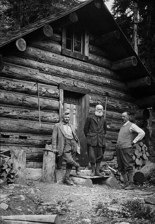 Edward Feuz Jr., Professor Charles Ernest Fay and Dr. Hickson standing in front of Fay Hut. August 1930.
