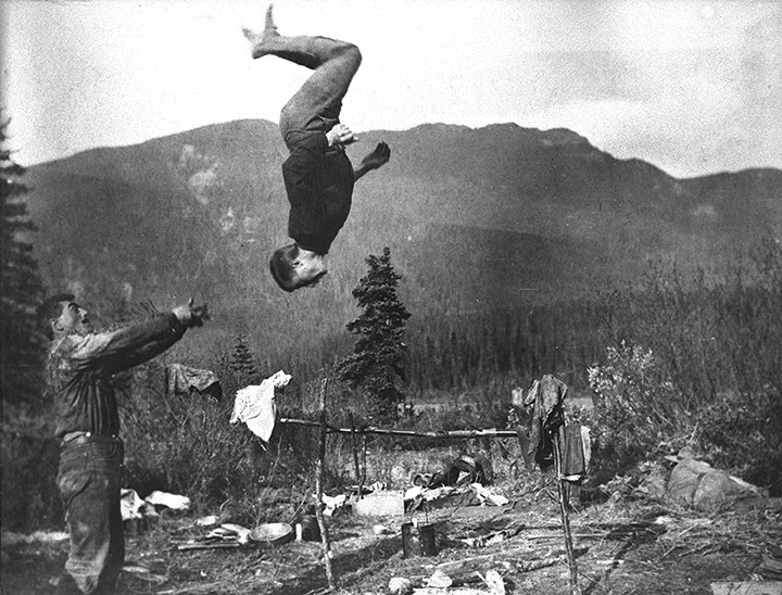 Jim Brewster with Phil Moore doing acrobatics, Brewster Brothers’ trip to Yellowhead Pass, 1904.