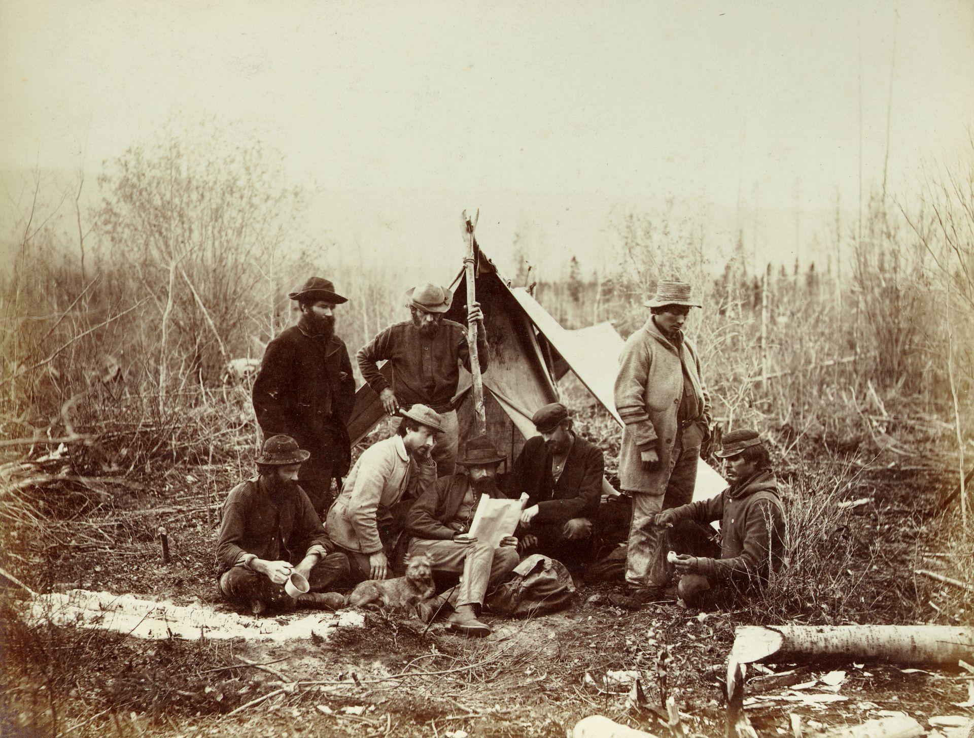 Geological Survey party in camp at Canoe River, October 14, 1871. Alfred Selwyn at centre with John Hammond (left centre) and Benjamin Baltzly (right centre)